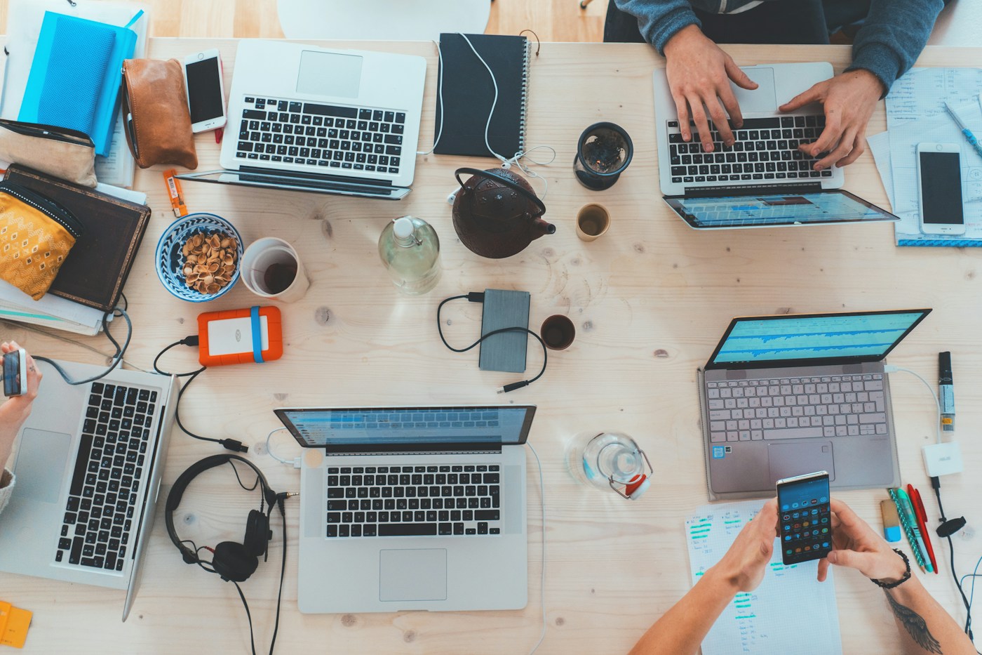 A collaborative team developing digital media strategy around a shared table