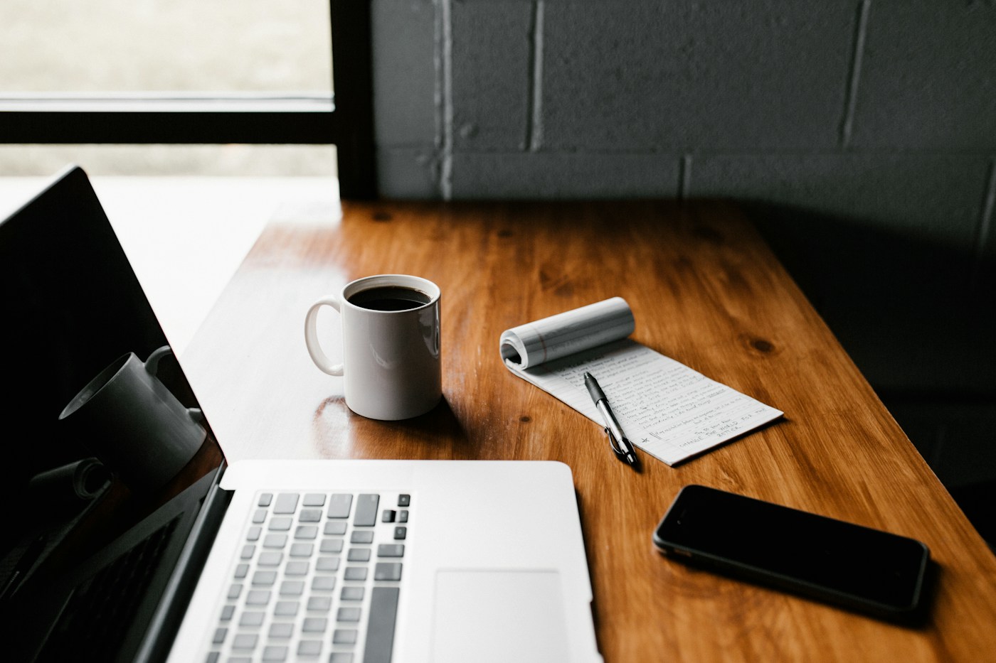An editorial workspace with a laptop and notebook for developing reusable content